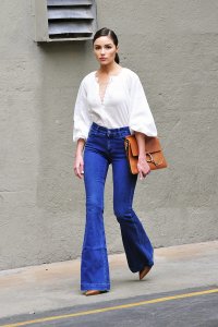 Olivia Palermo is wearing a pair of flared jeans, which are the trend for spring. 
